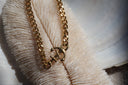 Gold-tone chain bracelet with an anchor centrepiece and twisted rope detail.