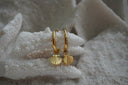 Alternate view: gold-tone hoop earrings with hanging scallop-shell charms and radiating ridges.