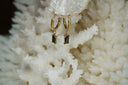 Gold-tone hoop earrings with rectangular black faceted drops in corner-prong frames.