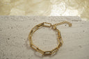 Gold-tone bracelet with alternating smooth and textured rectangular links, a clasp and extension chain.