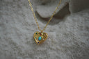 Alternate view: gold-tone heart necklace with a blue-green iridescent oval, coloured accents and elongated chain links.