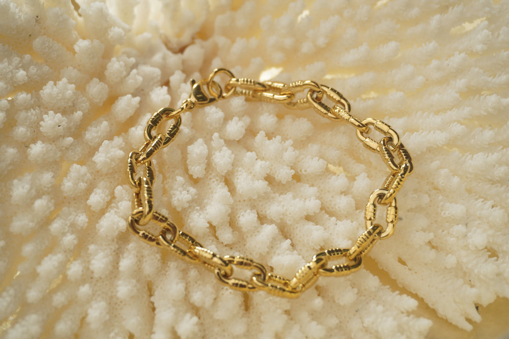 Alternate view: gold-tone bracelet with thick oval links, ridged side sections and a clasp.