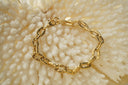 Alternate view: gold-tone bracelet with thick oval links, ridged side sections and a clasp.
