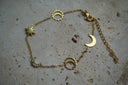 Alternate view: gold-tone chain bracelet with crescent moons, pointed stars and open sun motifs.