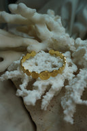 Alternate view: gold-tone open cuff formed from graduated discs with radiating lines and raised centres.