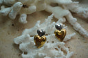 Alternate view: earrings with a small silver-tone heart above a larger reflective gold-tone heart.