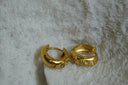Gold-tone hoops with raised sun, crescent and eye motifs and clear accents.