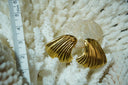 Gold-tone asymmetric fan-shaped earrings with long curved grooves and flared edges.