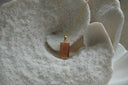 Gold-tone chain necklace with a reflective rectangular The Devil pendant, hand-gesture illustration and XV lettering.