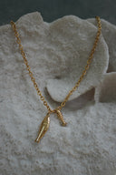 Gold-tone link necklace with two hanging fish-shaped charms.